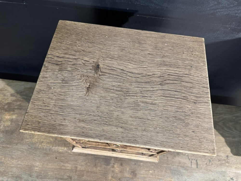 A pair of light oak three-drawer bedside chests with geometric carved drawer fronts, brass ring handles, and turned bun feet. View X