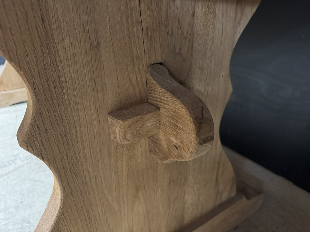 A large bleached oak farmhouse dining table featuring a thick plank top supported by a trestle base with a centre stretcher. View VIII