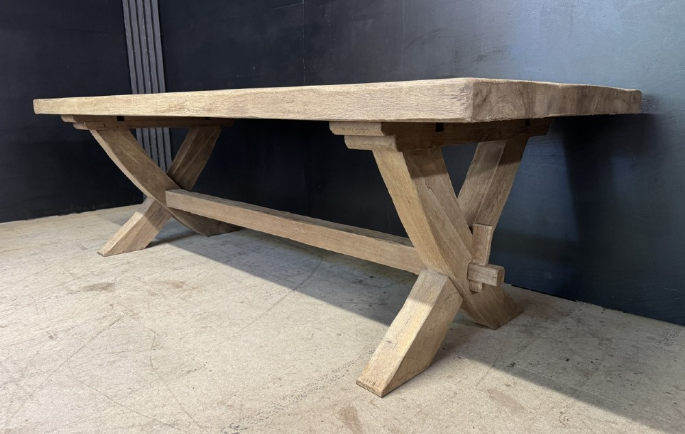 A large solid light oak dining table featuring an X-frame trestle base and a central key-joined stretcher. View IV