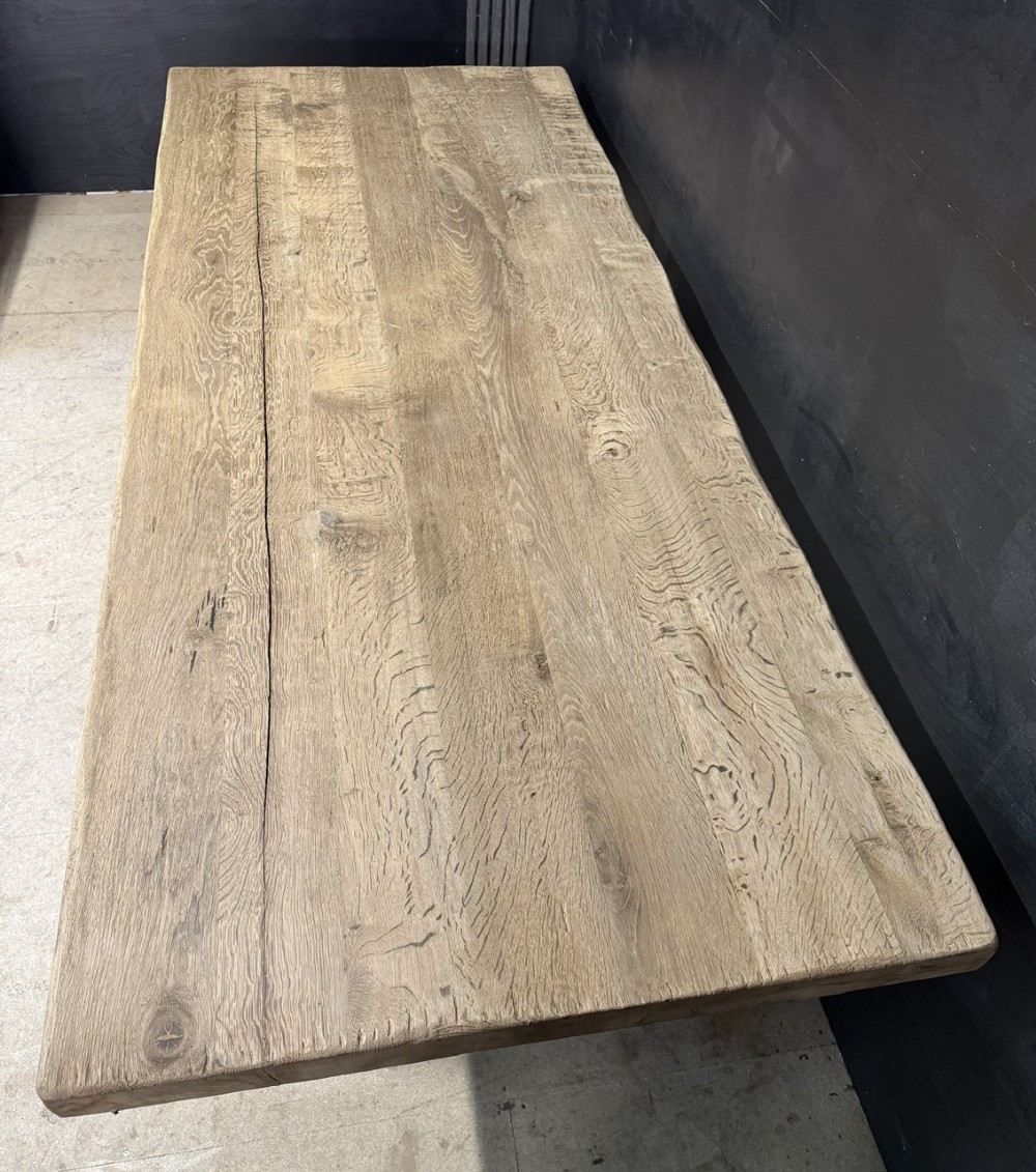 A large solid light oak dining table featuring an X-frame trestle base and a central key-joined stretcher. View V