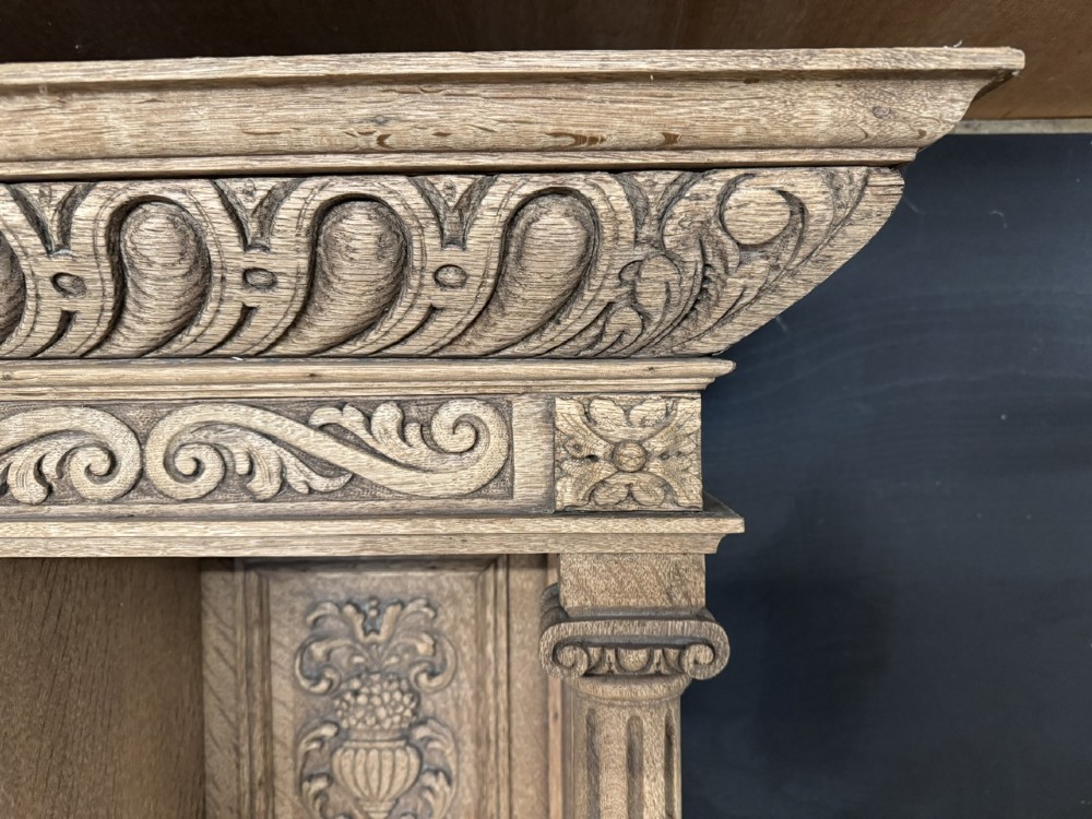 A large carved light oak sideboard with an upper cupboard section, a central mirror plate, turned columns, and detailed relief carvings throughout. View VIII