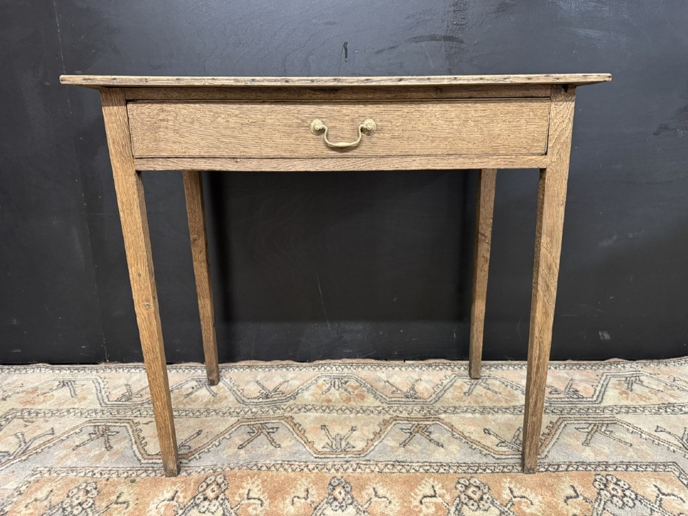 A Georgian oak side table featuring a single frieze drawer with a brass swan-neck handle and four square legs. View III