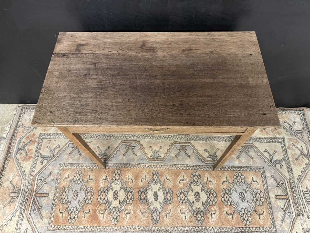 A Georgian oak side table featuring a single frieze drawer with a brass swan-neck handle and four square legs. View IV