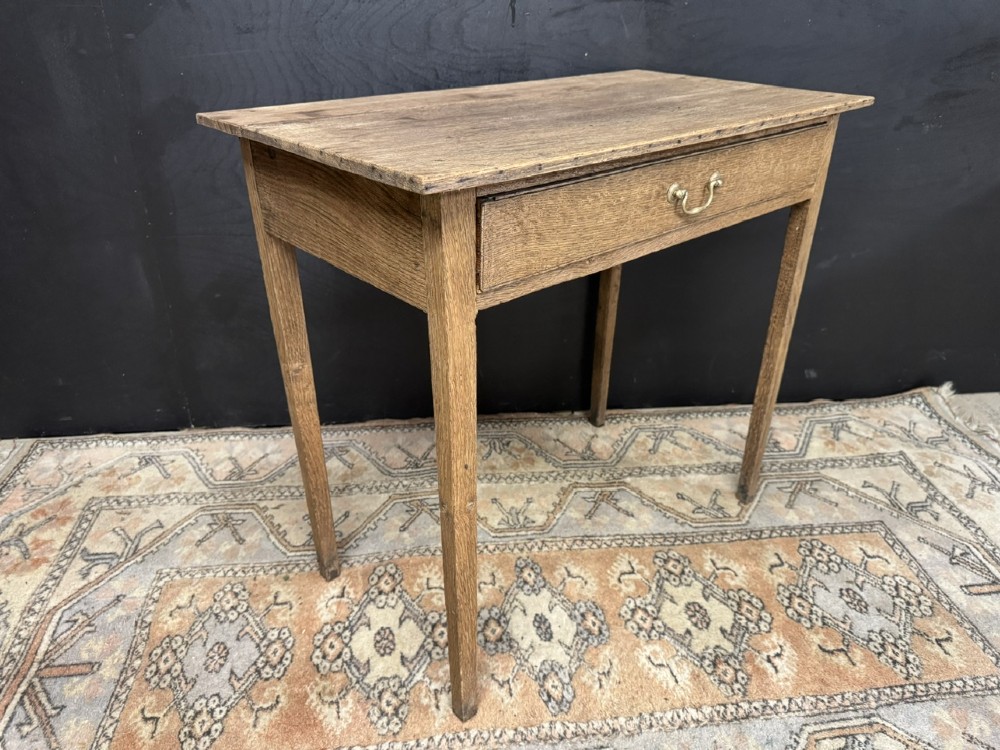 A Georgian oak side table featuring a single frieze drawer with a brass swan-neck handle and four square legs. View VII