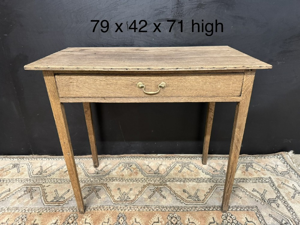 A Georgian oak side table featuring a single frieze drawer with a brass swan-neck handle and four square legs. View X