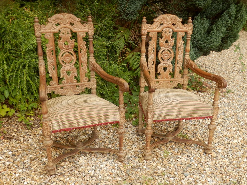 A pair of limed oak arm chairs