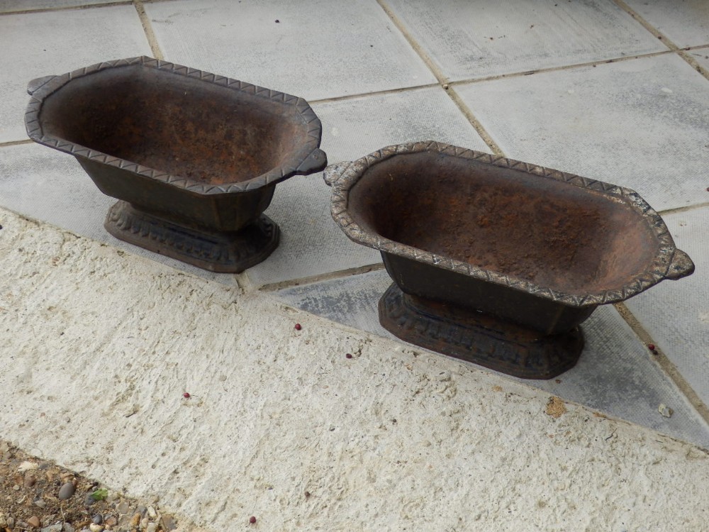 A pair of cast iron garden urns