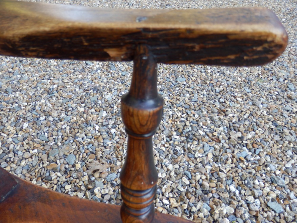 A Victorian wooden Windsor carver armchair featuring a high slat back, turned front legs, curved armrests, and a saddle seat in a dark brown timber finish. View IX