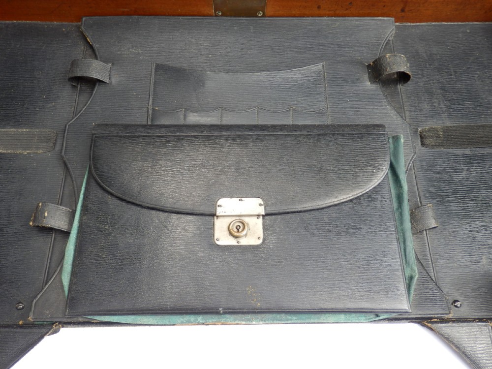A Victorian mahogany folding writing desk featuring curved X-frame legs, an open writing tray top with a leather insert, and a built-in inkwell compartment. View XI