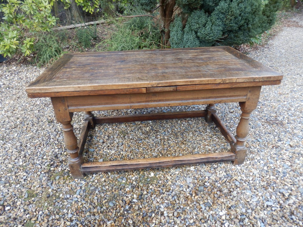 An extended antique Georgian oak dining table featuring turned legs, perimeter box stretchers, and draw-leaf extensions extending to 2.9 metres. View II