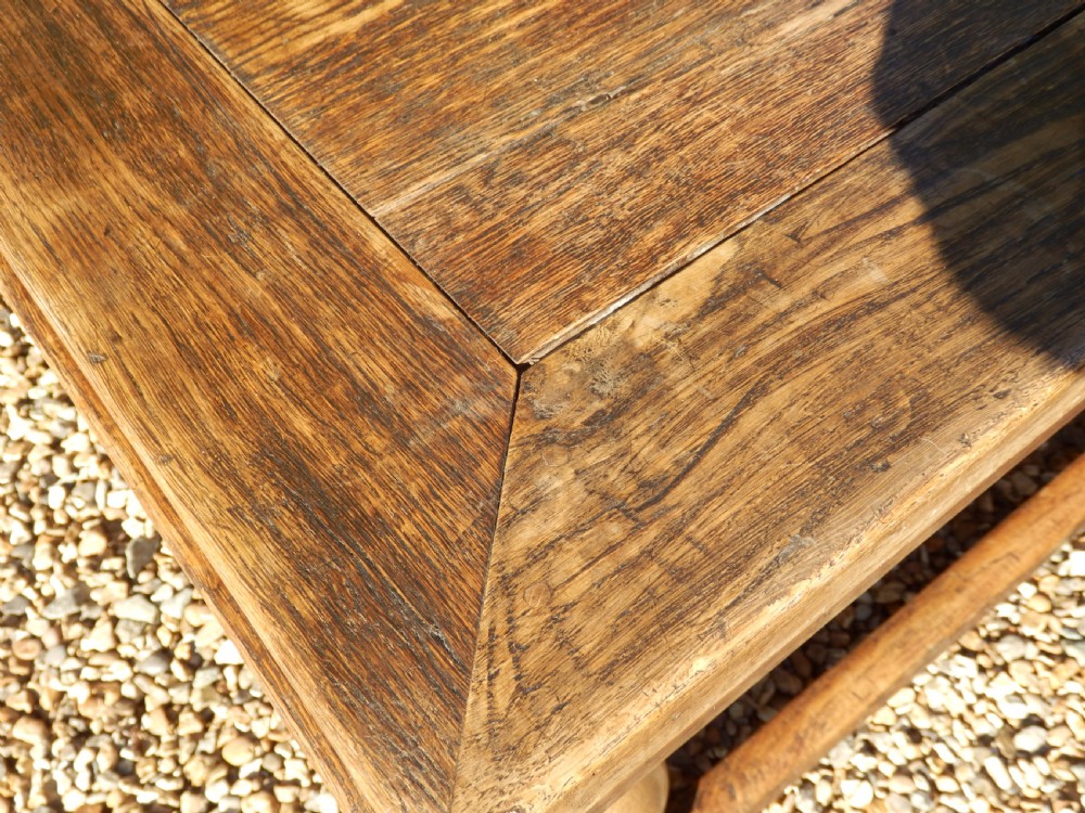 An extended antique Georgian oak dining table featuring turned legs, perimeter box stretchers, and draw-leaf extensions extending to 2.9 metres. View III