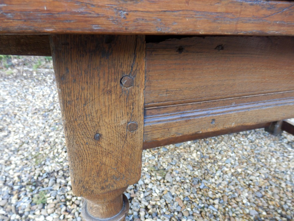 An extended antique Georgian oak dining table featuring turned legs, perimeter box stretchers, and draw-leaf extensions extending to 2.9 metres. View VII