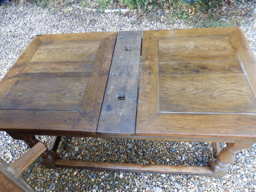 An extended antique Georgian oak dining table featuring turned legs, perimeter box stretchers, and draw-leaf extensions extending to 2.9 metres. View IX