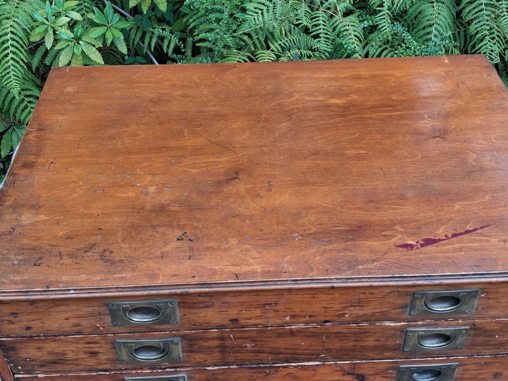 A solid pine architects plan chest featuring ten wide, shallow drawers fitted with inset brass flush pull handles. View VII