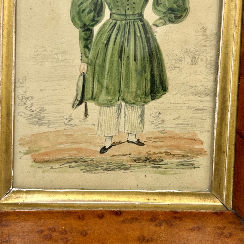 An antique watercolour portrait of a child wearing a green dress framed in figured maple wood with a gilded inner rim. View IV