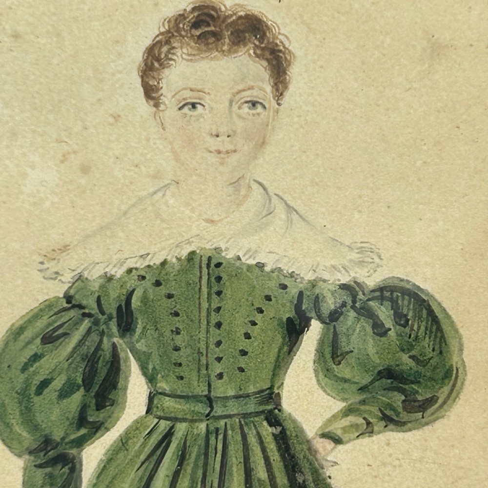An antique watercolour portrait of a child wearing a green dress framed in figured maple wood with a gilded inner rim. View VI