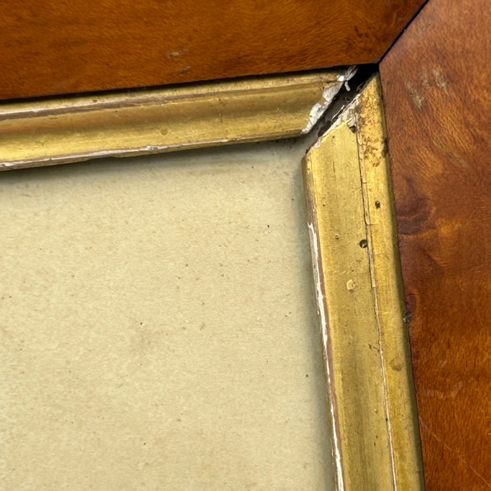 An antique watercolour portrait of a child wearing a green dress framed in figured maple wood with a gilded inner rim. View VII