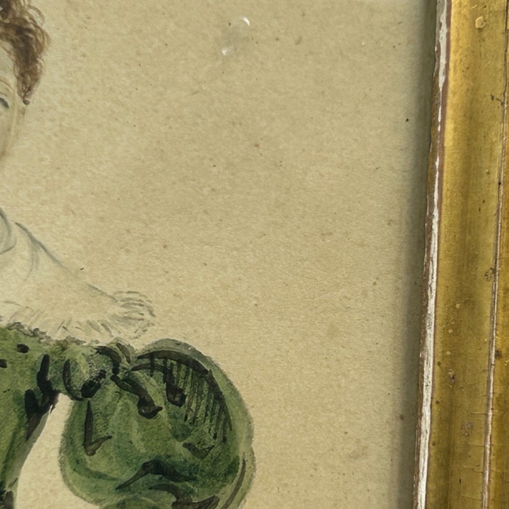An antique watercolour portrait of a child wearing a green dress framed in figured maple wood with a gilded inner rim. View VIII