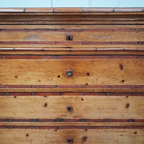 fig 1. A tall 19th-century French wooden semainier chest featuring seven drawers framed by turned faux bamboo mouldings and supported by bun feet.