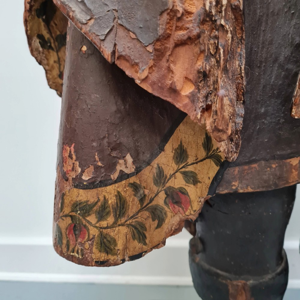 Full-length carved wood polychrome figure of a standing man in 17th-century attire on an inscribed rectangular base. View IV