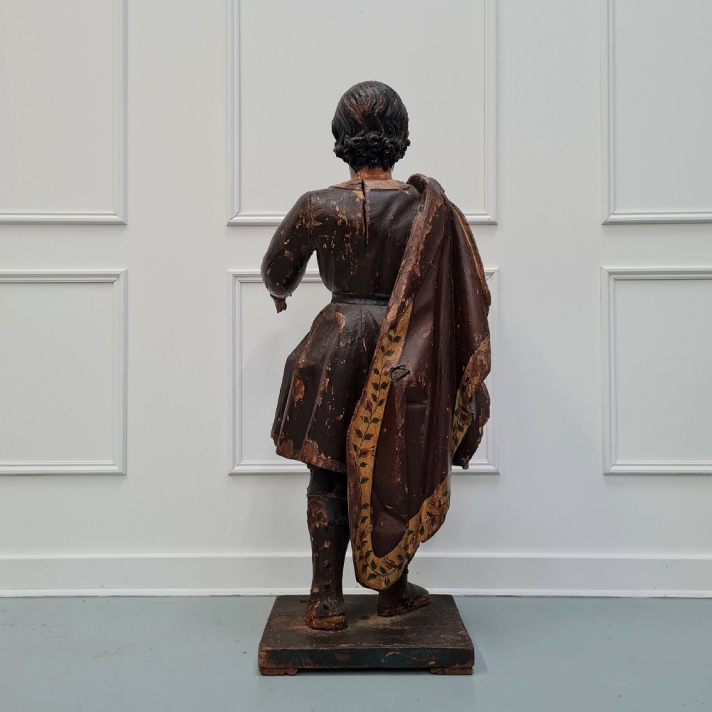 Full-length carved wood polychrome figure of a standing man in 17th-century attire on an inscribed rectangular base. View VII
