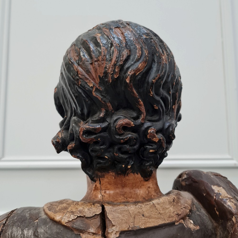 Full-length carved wood polychrome figure of a standing man in 17th-century attire on an inscribed rectangular base. View IX