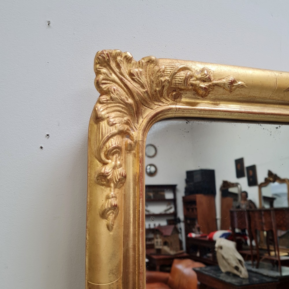 A tall rectangular French antique floor mirror featuring a gold gilded frame with rounded top corners and leaf details. View III