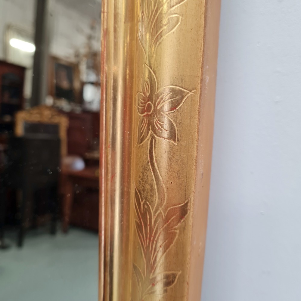A tall rectangular French antique floor mirror featuring a gold gilded frame with rounded top corners and leaf details. View IV