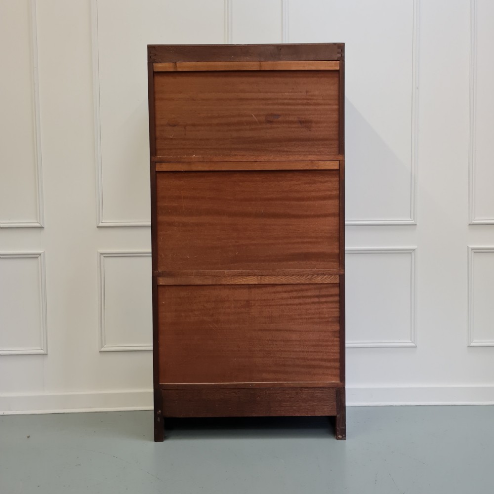 A tall dark mahogany 1930s French stacking haberdashery bookcase featuring two upper glazed compartments above a solid timber lower section. View VIII