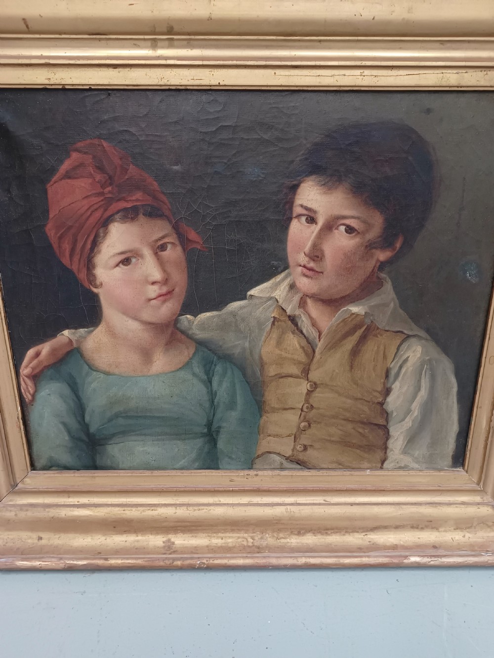 A Georgian era oil painting depicting two siblings in period attire within a moulded gold gilt frame. View III