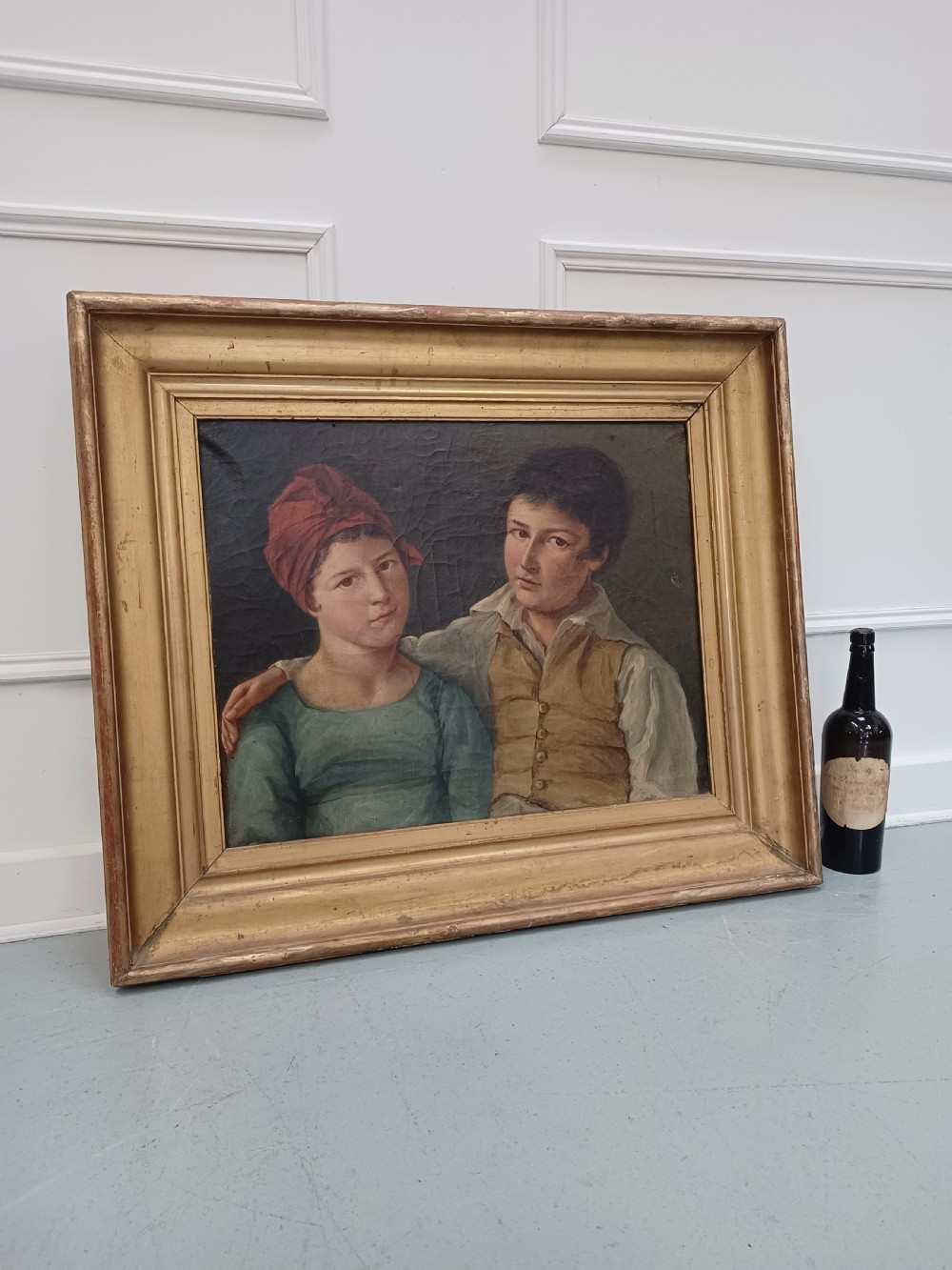 A Georgian era oil painting depicting two siblings in period attire within a moulded gold gilt frame. View IV