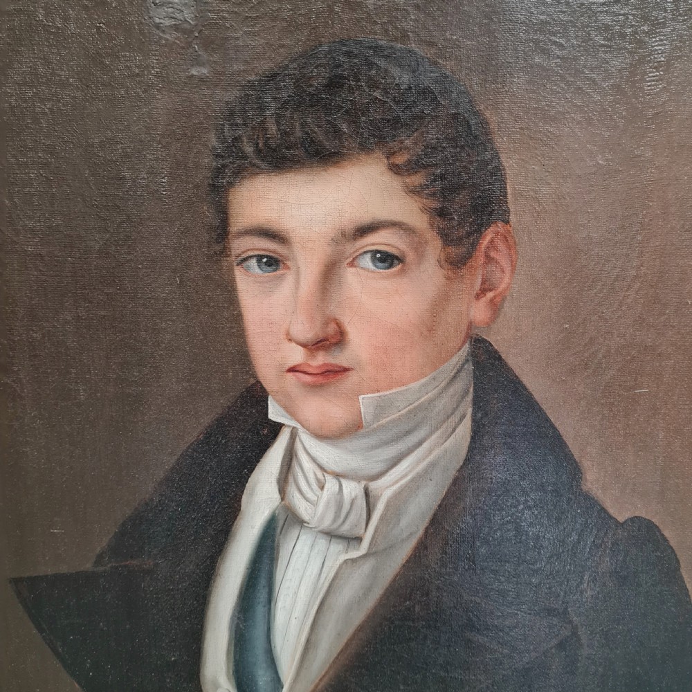 An antique oil portrait painting on canvas depicting a young male in 19th-century attire within an ornate gilded wooden frame. View II