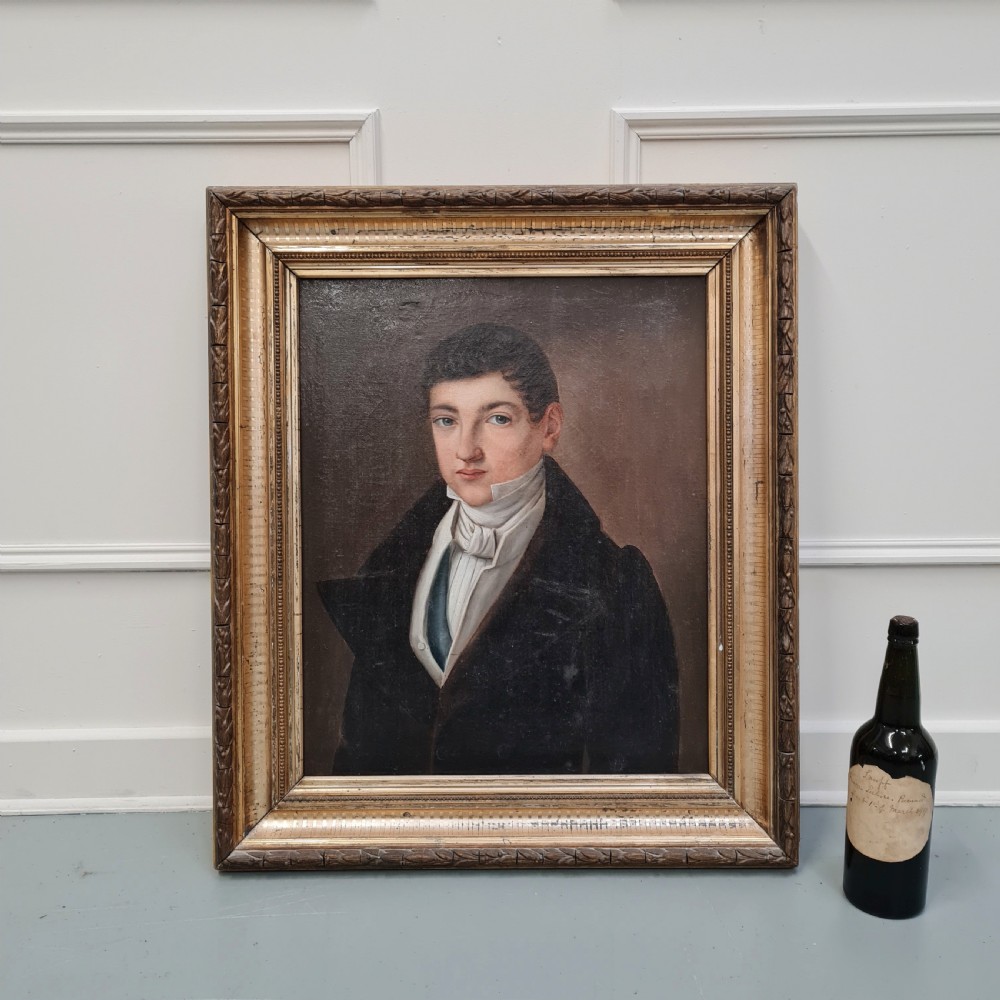 An antique oil portrait painting on canvas depicting a young male in 19th-century attire within an ornate gilded wooden frame. View III