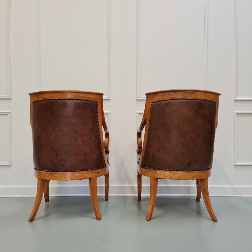 Pair of mid-19th-century ash wood armchairs featuring brown leather upholstery, stud detailing, and carved scrolled armrests. View III