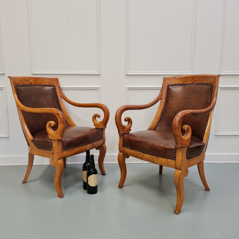 Pair of mid-19th-century ash wood armchairs featuring brown leather upholstery, stud detailing, and carved scrolled armrests. View VIII