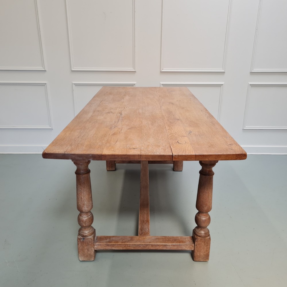 A late 19th-century oak refectory dining table featuring turned legs and a low rectangular stretcher base. View II