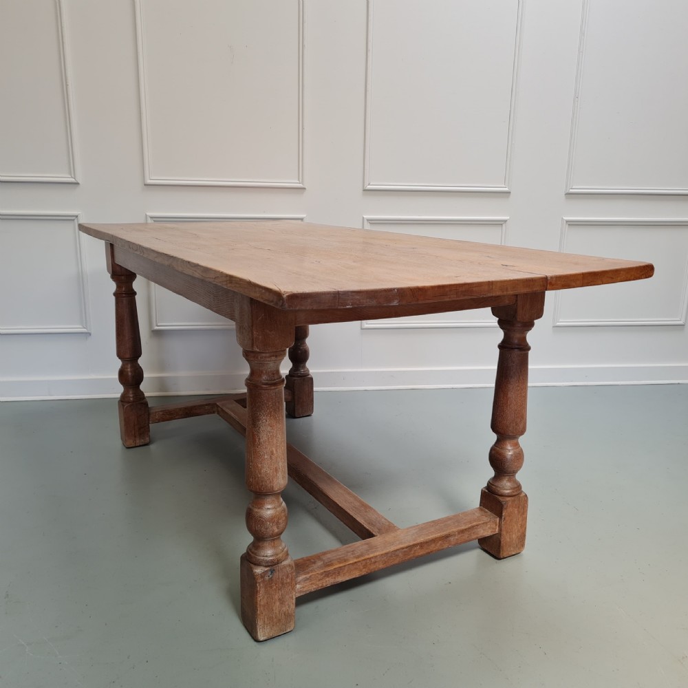 A late 19th-century oak refectory dining table featuring turned legs and a low rectangular stretcher base. View IV