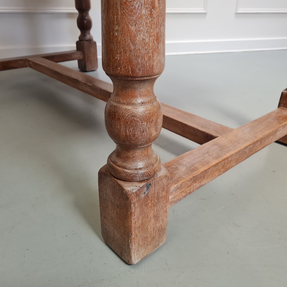 A late 19th-century oak refectory dining table featuring turned legs and a low rectangular stretcher base. View VI