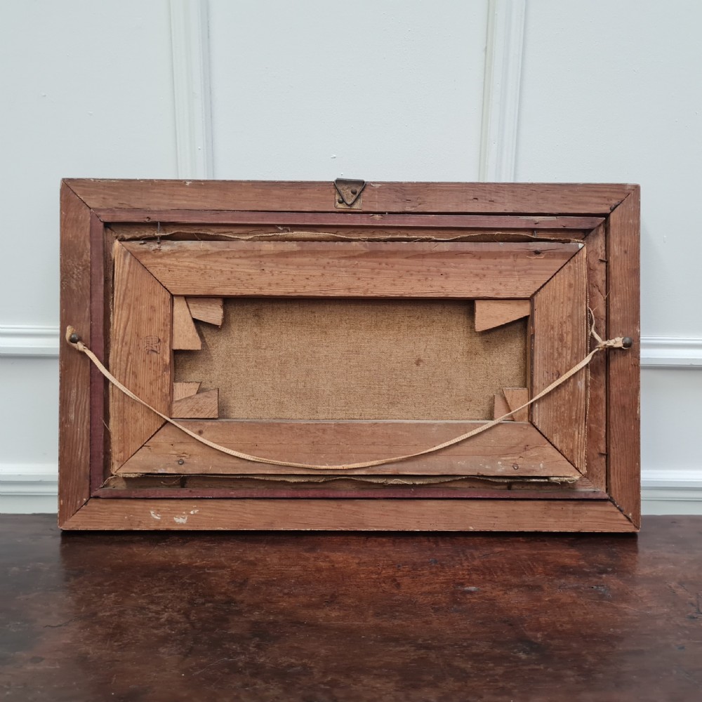 A Victorian oil painting depicting three kittens seated together inside a carved gilded rope-twist wooden frame. View II
