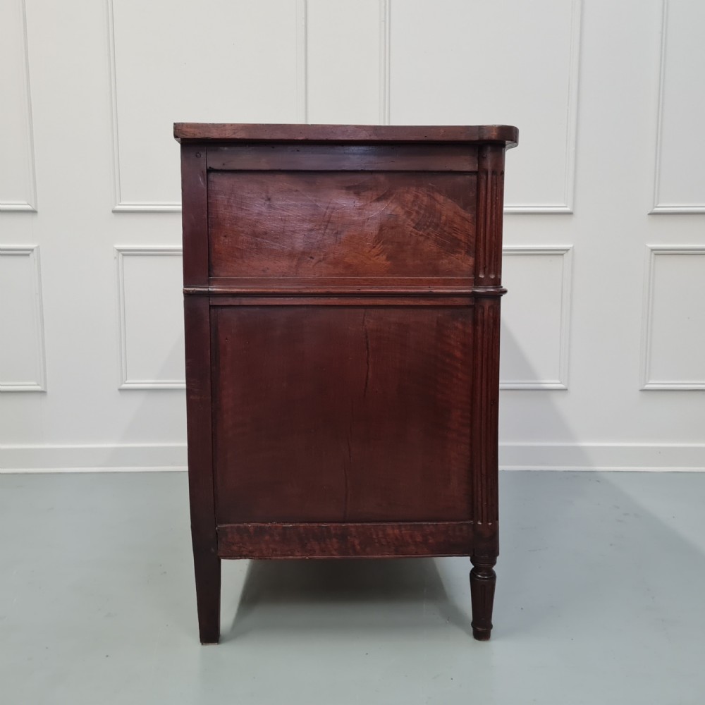 An early antique French cherry commode featuring three long drawers with brass drop handles and escutcheons. View III