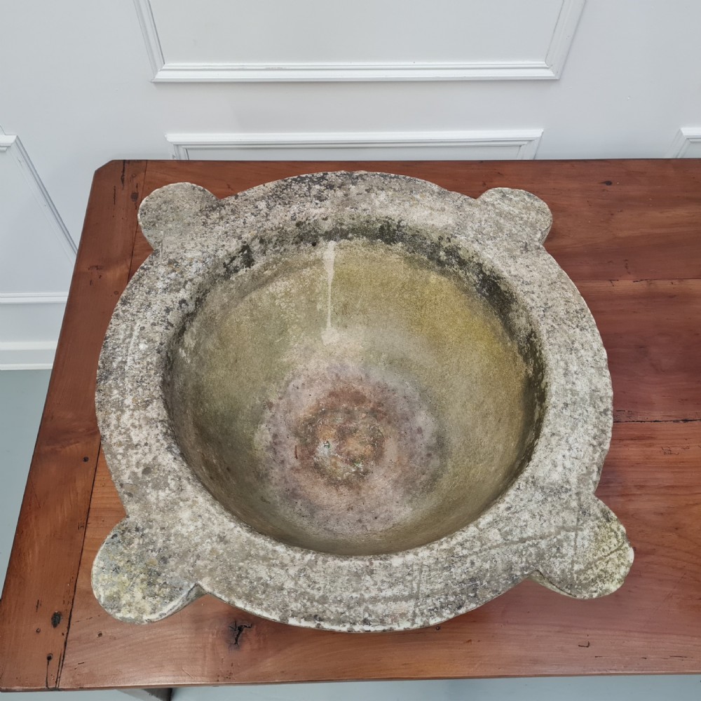 An 18th-century carved white marble mortar featuring four lug handles and a worn interior basin. View IV