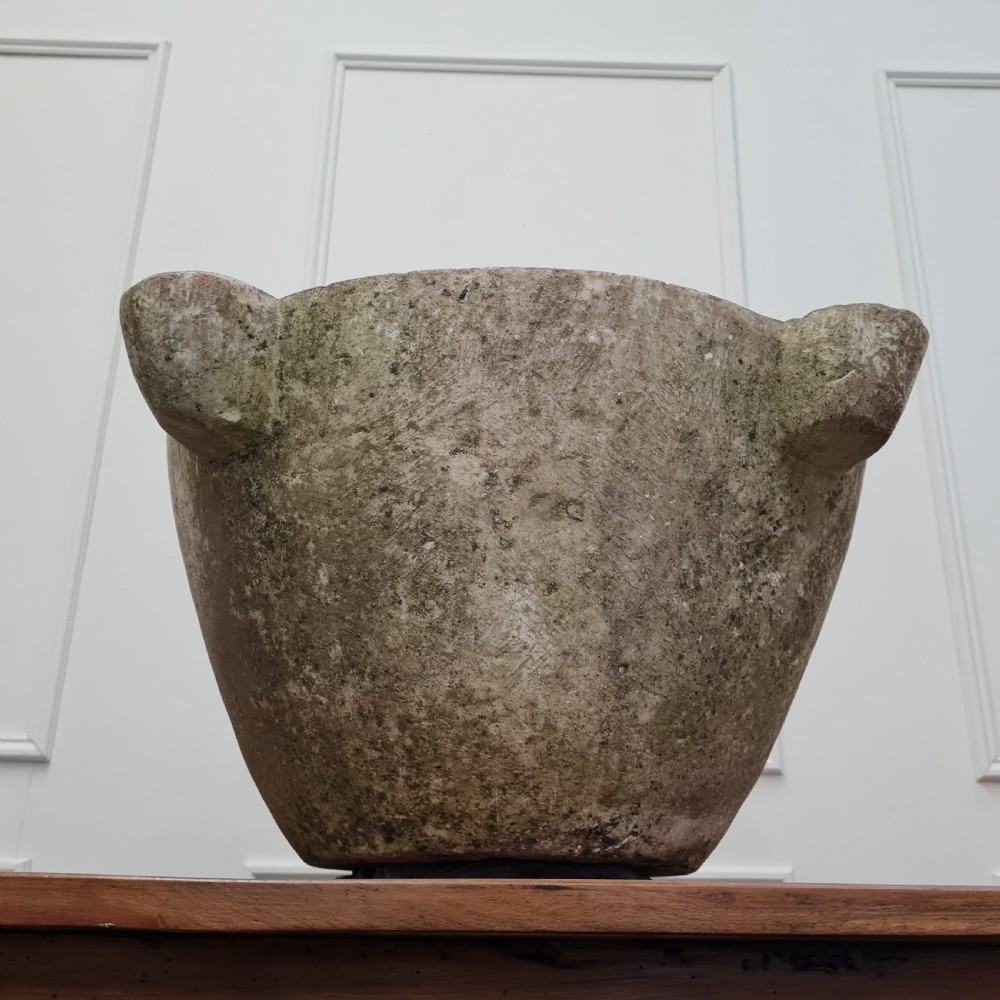 An 18th-century carved white marble mortar featuring four lug handles and a worn interior basin. View V