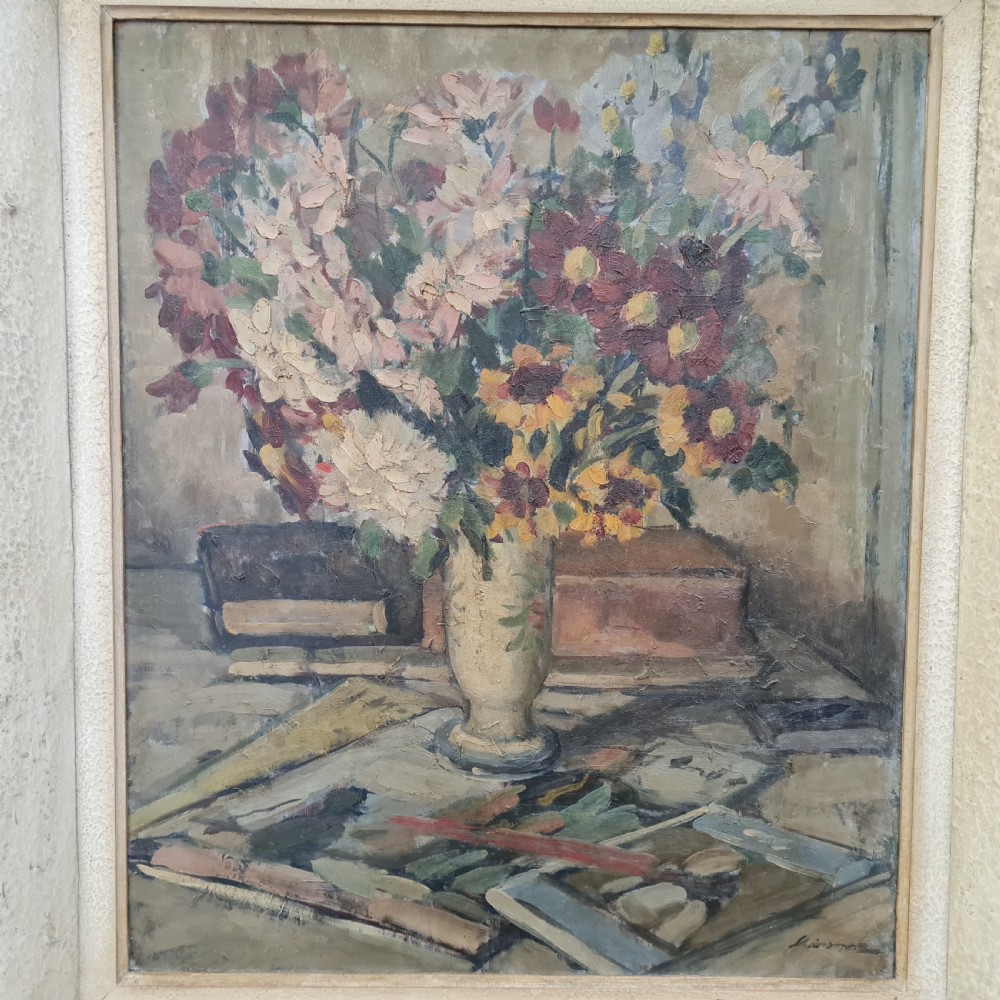 A pair of framed 1930s oil paintings depicting floral arrangements and fruit still life compositions in cream painted wooden frames. View VII