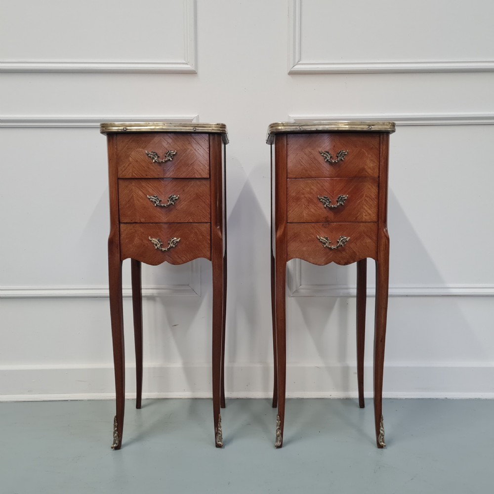 A pair of tall French kingwood bedside cabinets featuring three drawers, brass handles, cabriole legs, and top brass gallery rims. View II