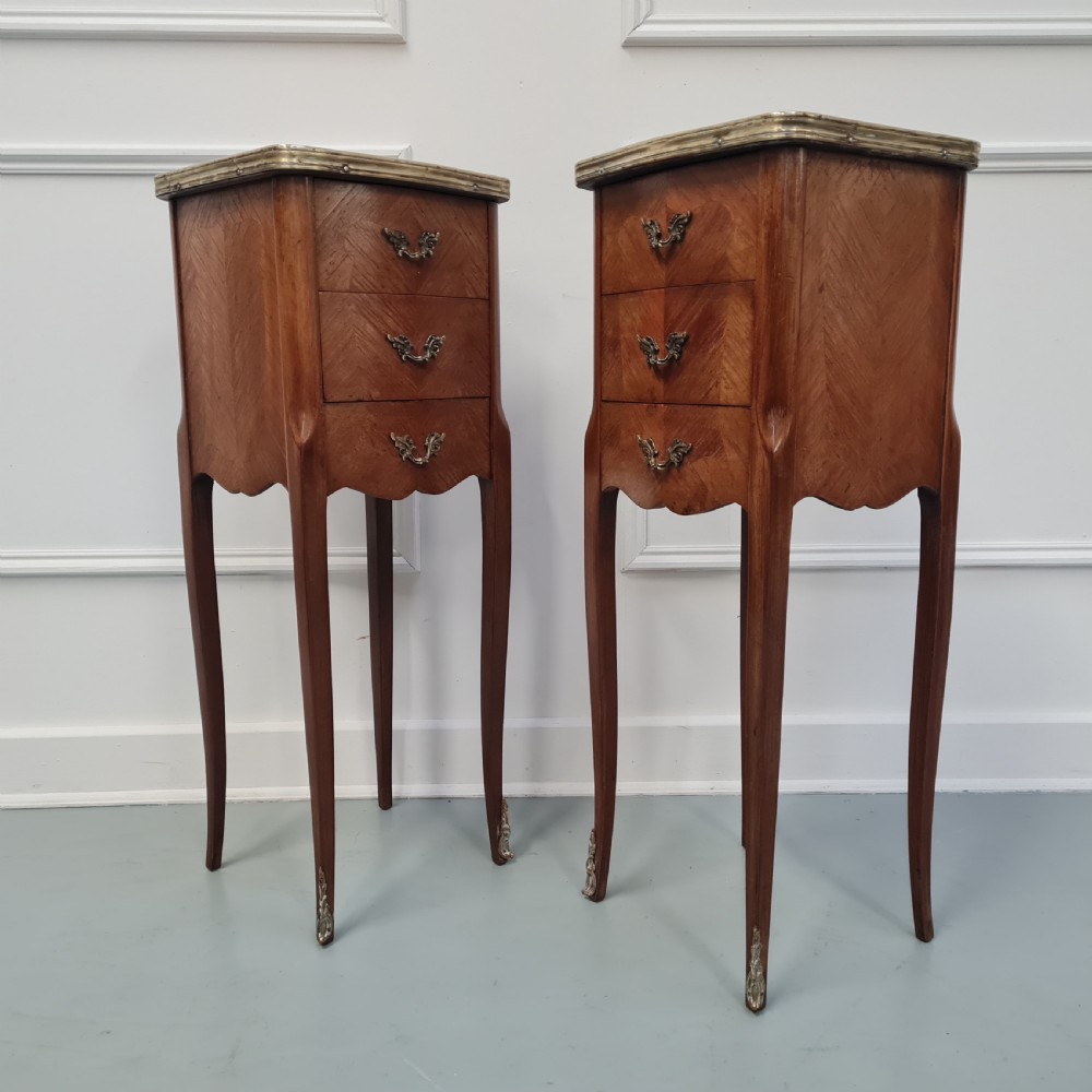 A pair of tall French kingwood bedside cabinets featuring three drawers, brass handles, cabriole legs, and top brass gallery rims. View III