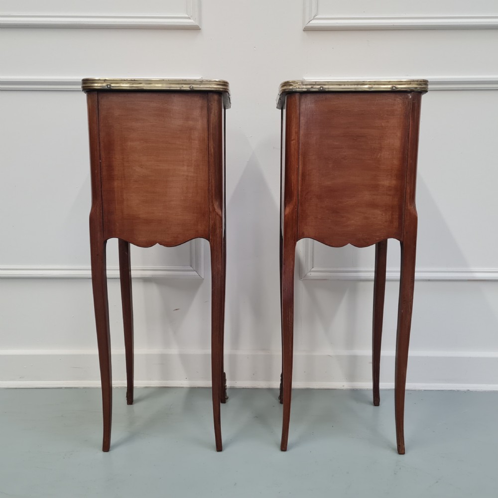A pair of tall French kingwood bedside cabinets featuring three drawers, brass handles, cabriole legs, and top brass gallery rims. View V