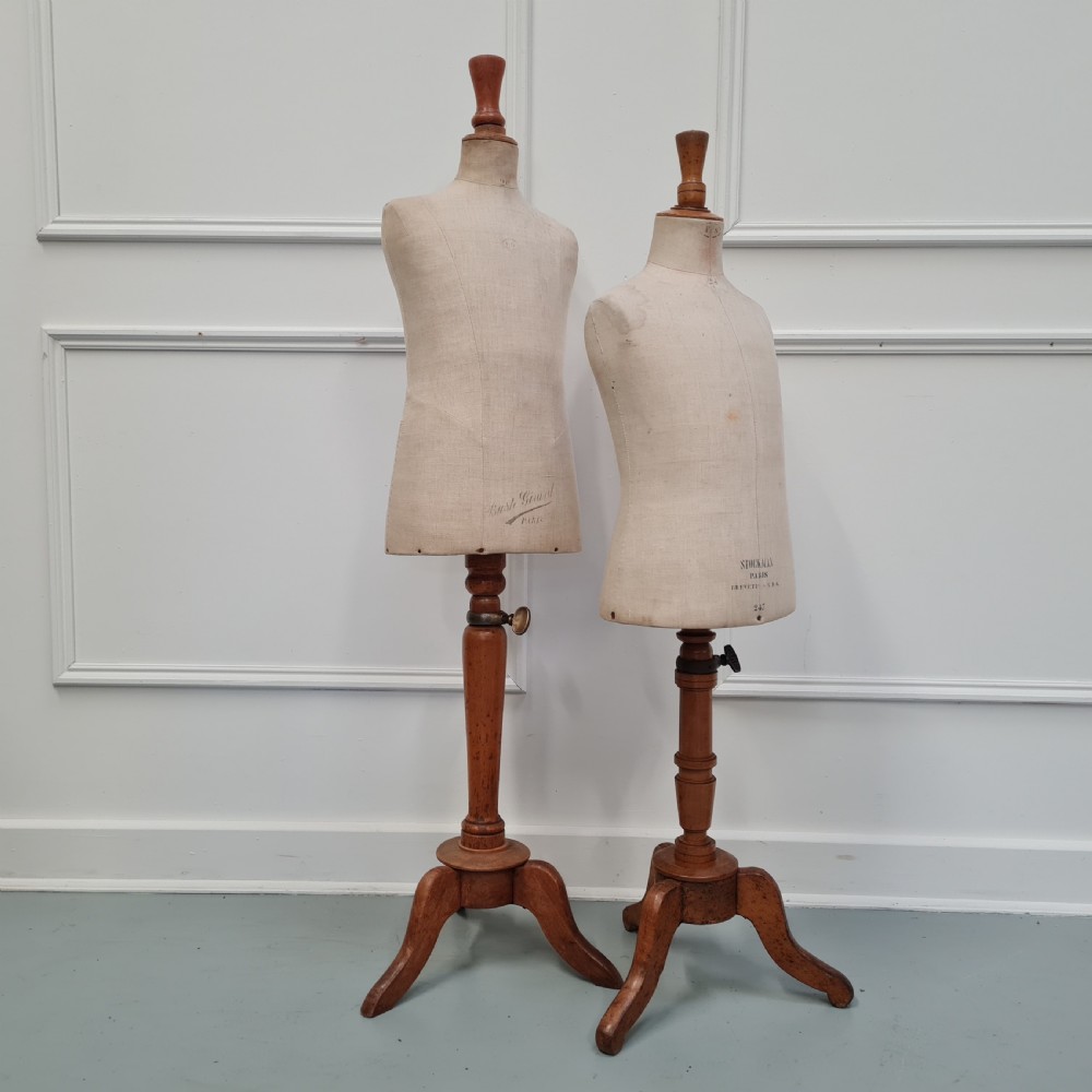 An antique French child-sized tailor mannequin by Stockman featuring a beige linen torso mounted on a turned wooden tripod stand. View VII