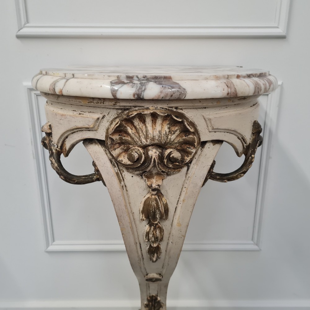 A pair of French nineteenth-century wall-mounted console tables with shaped marble tops and carved gilded single support legs. View IV
