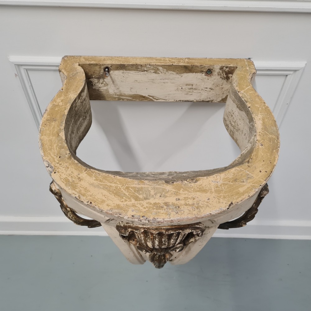 A pair of French nineteenth-century wall-mounted console tables with shaped marble tops and carved gilded single support legs. View XI