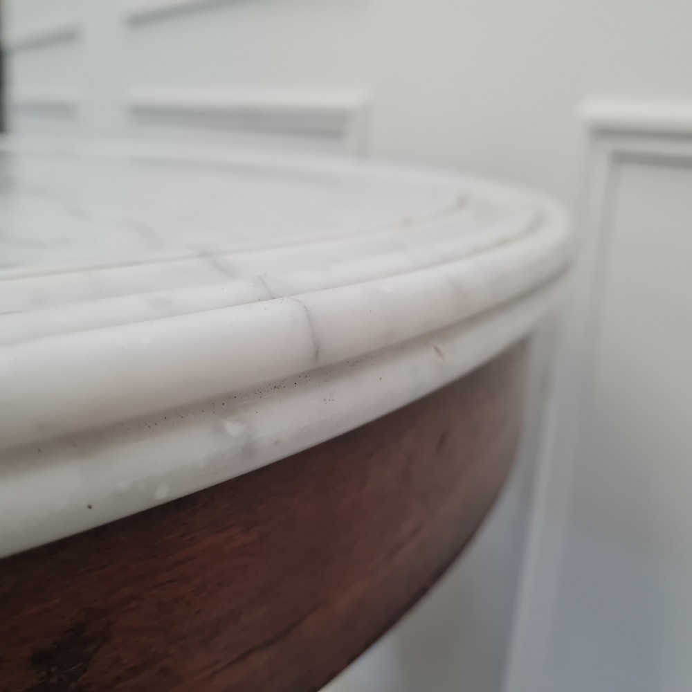 A 19th-century French gueridon table featuring a circular white marble top supported by a carved dark mahogany pedestal and scrolled tripod base. View VI